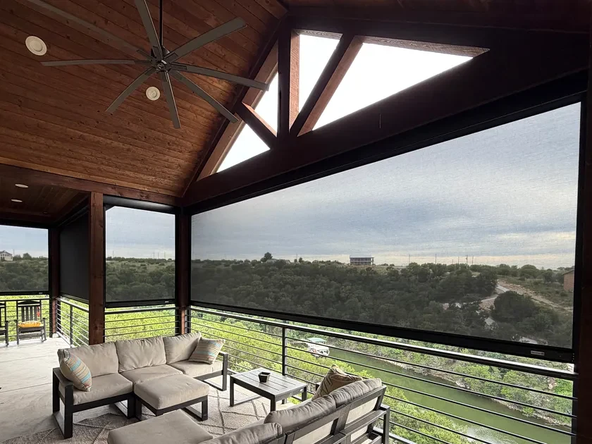 Lake porch with a right-hand screen lowered over a green cove