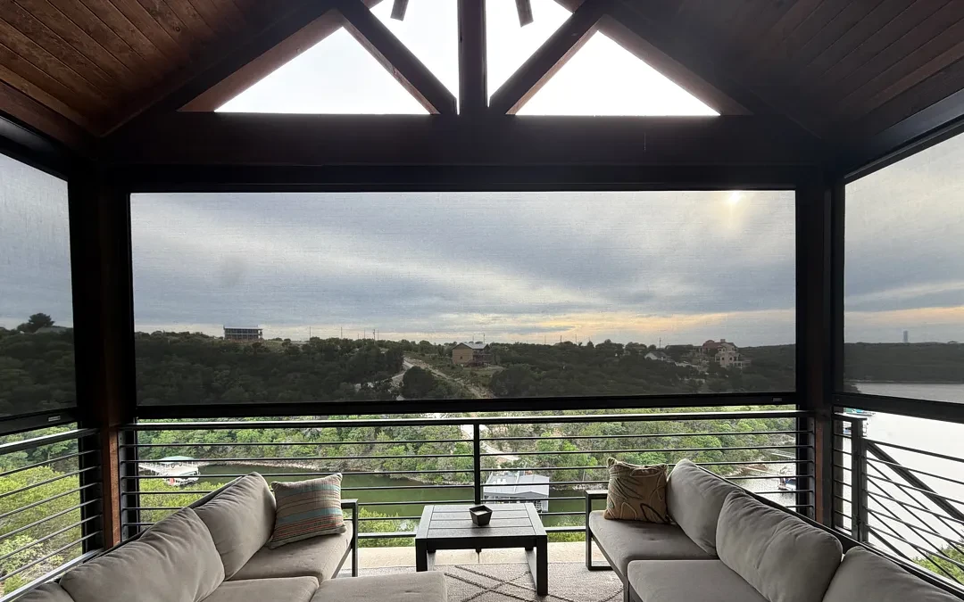 View from a Graford lake porch through the seating, with a lowered screen framing the cove and lake beyond